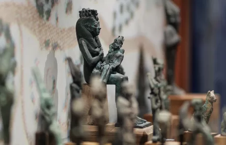 MAEC Cortona collezione egizia. Iside seduta con Horus sulle ginocchia, in atto di allattarlo, su base trapezoidale. 